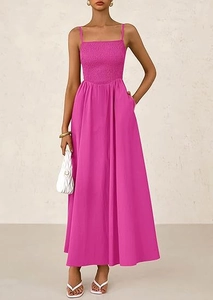 Detail of smocked magenta midi dress featuring spaghetti straps and side pockets