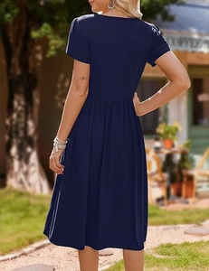 Side-back view of navy blue short sleeve dress with fitted waist and A-line silhouette