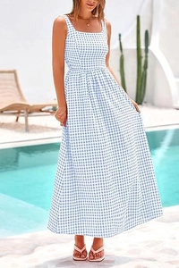 Outdoor shot of a blue and white gingham maxi dress with a square neck and tiered skirt