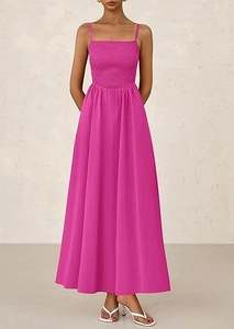 Detail of fuchsia pleated smocked bodice and thin straps on long summer dress