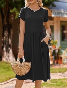 Detail of a black short sleeve dress featuring practical side pockets and a tulip cuff
