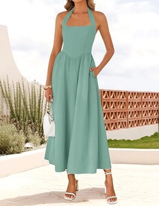 Detail showing the halter neck, V-waistline, and practical side pockets of the mint green dress