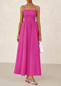 Detail of smocked bodice and thin straps on a vibrant fuchsia summer maxi dress
