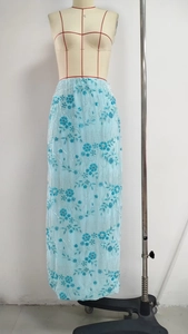 Detailed view of light blue sequin floral embroidery on a sheer mesh maxi skirt