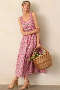 Detail of pink floral maxi dress featuring tiered skirt and drawstring neckline
