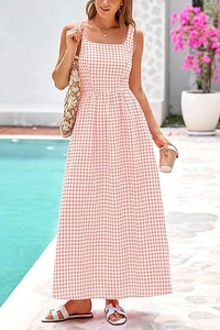 Pink gingham maxi dress featuring square neckline and flowy A-line skirt poolside