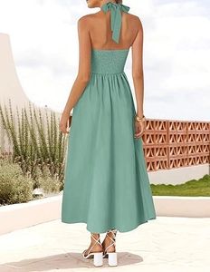 Detail of sage green halter neck dress showing back bow tie and elastic smocked bodice