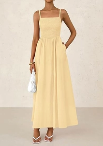 Close-up of smocked bodice and thin straps on a cream yellow maxi sun dress