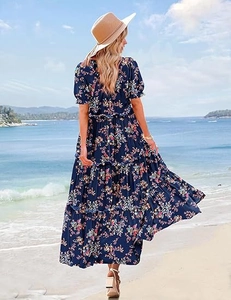 Detail of tiered floral maxi dress back view with bubble sleeves on a sunny beach