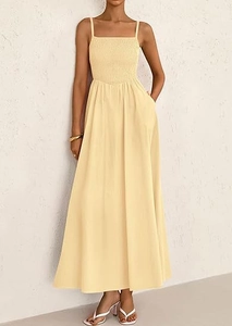 Detail of smocked bodice and thin straps on a light yellow sundress with side pockets