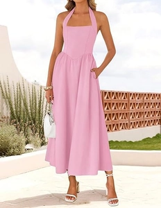 Detail of pink halter neck dress with V-shaped waist seam and practical side pockets