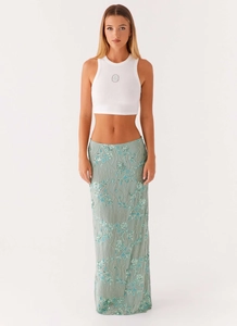 Detailed view of floral sequin embroidery and beadwork on a mint green maxi skirt