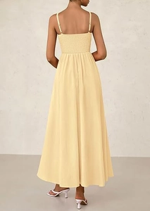 Detail view of the smocked back design and adjustable straps on the light yellow dress