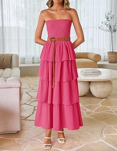 Detail of hot pink smocked bodice and tiered maxi dress with woven brown belt