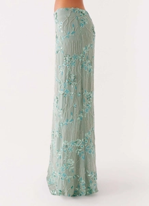 Detail of light green sequined maxi skirt with floral beadwork and intricate embroidery