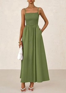 Sage green smocked sundress with thin straps and side pockets on a flowing A-line skirt
