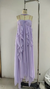 Macro detail of lavender chiffon dress with ruffled layers and irregular flowing hemline