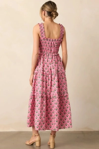 Detail view showing smocked back bodice and tiered floral skirt of the pink summer dress