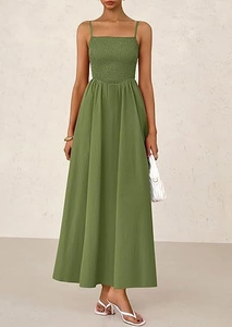 Detail view of avocado green pleated smocked bodice on a loose spaghetti strap dress