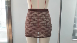 Close-up of brown floral lace pattern and elastic waistband on a slim-fit skirt