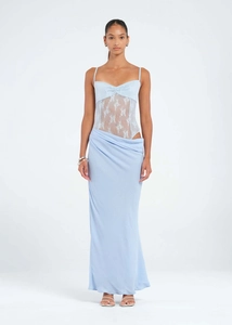 Close-up of lace patchwork detail and side cutout on a light blue bodycon fishtail dress