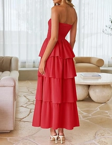 Detail of red strapless tiered maxi dress showing ruffled layers and smocked texture