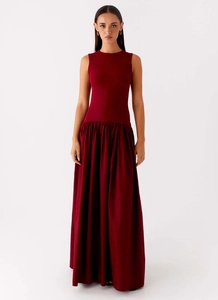 Detailed view of the sleeveless crewneck design and waist stitching on the wine red maxi dress