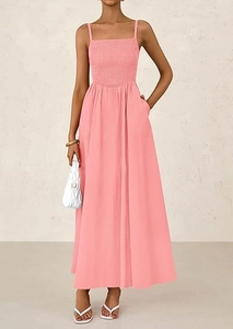 Detail of smocked pink spaghetti strap maxi dress with a flowing A-line skirt for summer