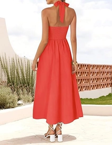 Detail of red halter dress featuring a smocked elastic back and an open back design