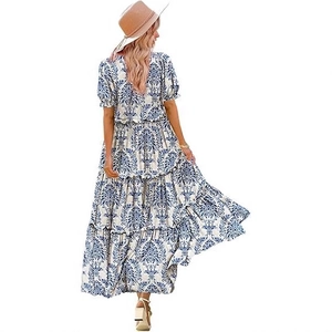 Back view of baroque print puff sleeve dress with tiered skirt and blue white pattern