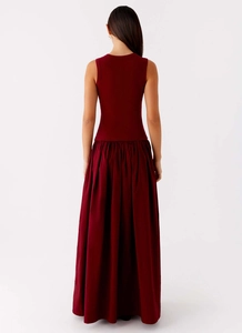 Rear view of wine red sleeveless maxi dress featuring a ribbed bodice and pleated skirt