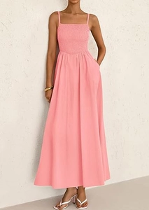 Macro detail of smocked bodice and thin straps on a pink maxi summer dress