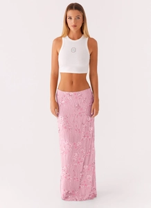 Detailed embroidery on a pink sequined floral skirt with elegant vine patterns