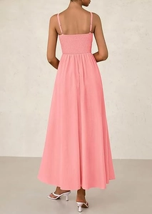 Detailed back view of pink smocked maxi dress with thin straps and ruffled elastic fabric