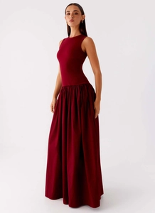 Detail view of burgundy sleeveless maxi dress with a fitted bodice and pleated A-line skirt