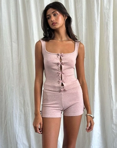 Detail of pink knitted camisole top featuring five decorative front bow ties and cutouts