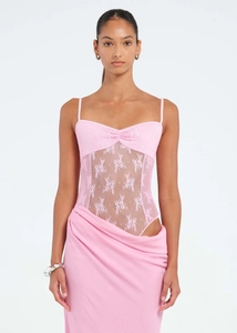 Detail of light pink floral lace stitching and sheer mesh on the slim-fit dress