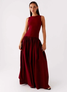 Detail showing the burgundy sleeveless dress with knitted rib bodice and pleated maxi skirt
