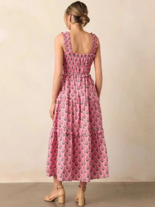Back view of an elegant pink floral maxi dress with tiered skirt and smocked waist