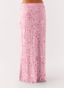 Detailed embroidery with beads and sequins on a pink slim fit evening maxi skirt