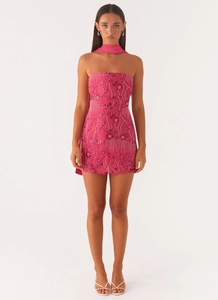 Detail of rose red sequin mini dress with floral embroidery and silk neck strap