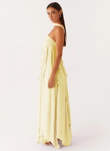 Detailed side view of light yellow backless maxi dress with ruffle layers and soft satin finish