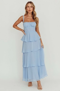 Detail view of the tiered ruffle hem and pleated bodice on a light blue maxi dress