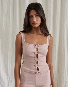 Detail of pink knitted tank top featuring square neckline and delicate bow embellishments