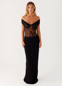 Close-up of elegant black lace embroidery and off-shoulder neckline on the dress