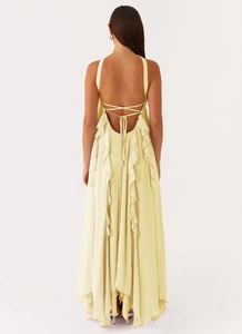 Detail of light yellow backless chiffon maxi dress with ruffles and lace-up straps