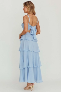 Detailed back view of light blue tiered cake dress with elegant bow and open back