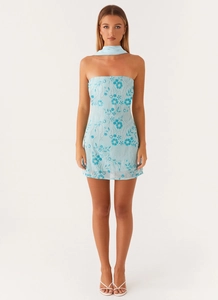 Detail of light blue mini dress featuring 3D floral embroidery and sparkling beads