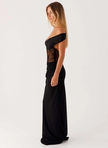 Detailed view of black lace off-shoulder bodice and sheer embroidery on long dress