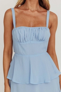 Detail of light blue square neck dress with ruched bust and peplum ruffle waist